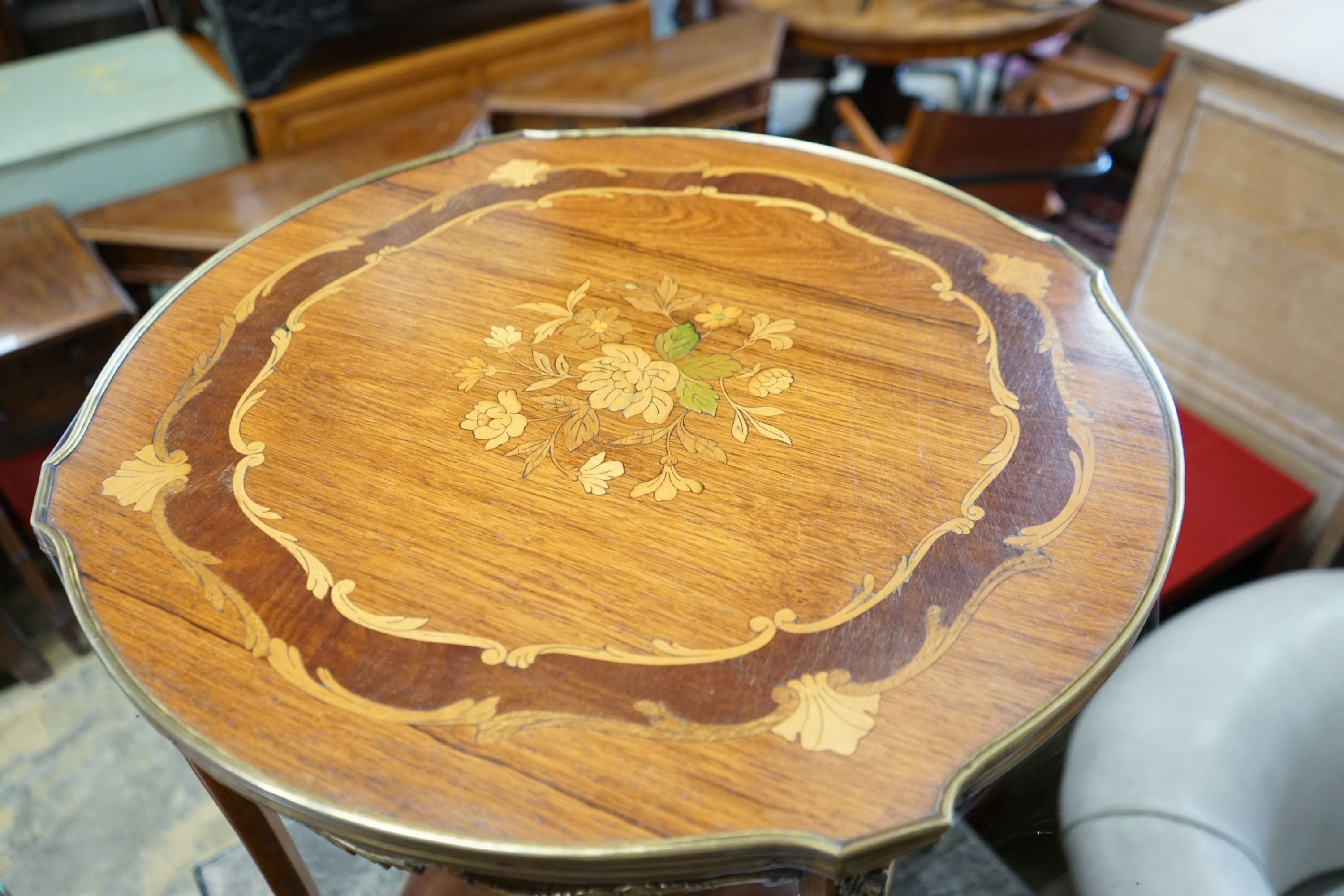 A Louis XVI style circular gilt metal mounted marquetry inlaid circular kingwood centre table, diameter 57cm, height 72cm